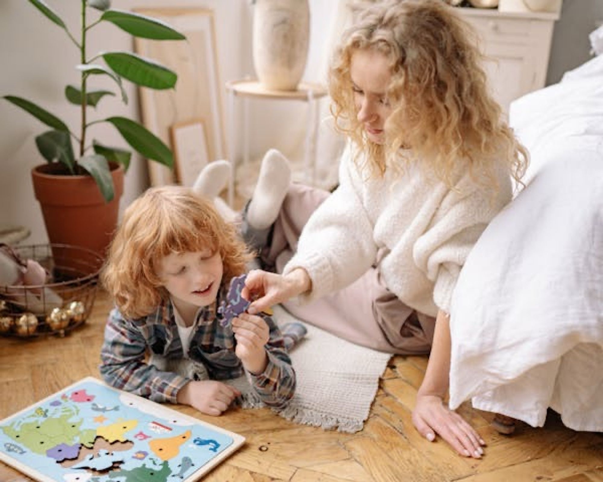 Mother and son completing a puzzle together